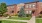 a large brick building with a tree in front of it