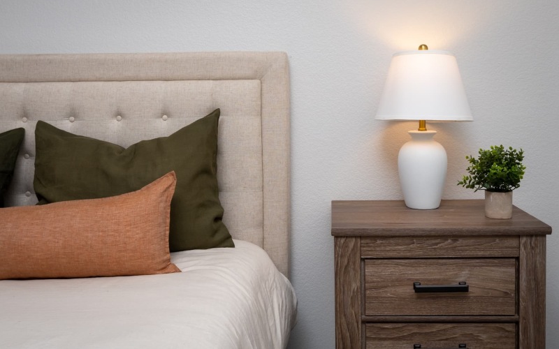 a bedroom with a nearby lamp