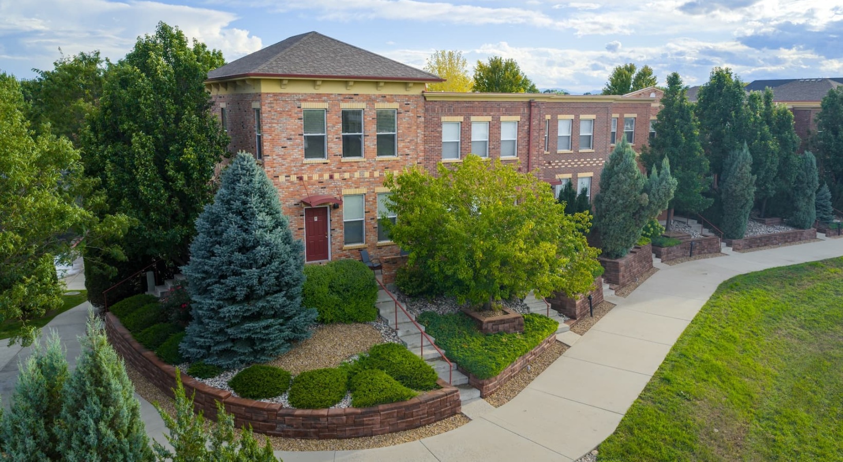 Find your perfect fit at Enclave Rigden Farms exteriors showing landscaping and accessible sidewalks