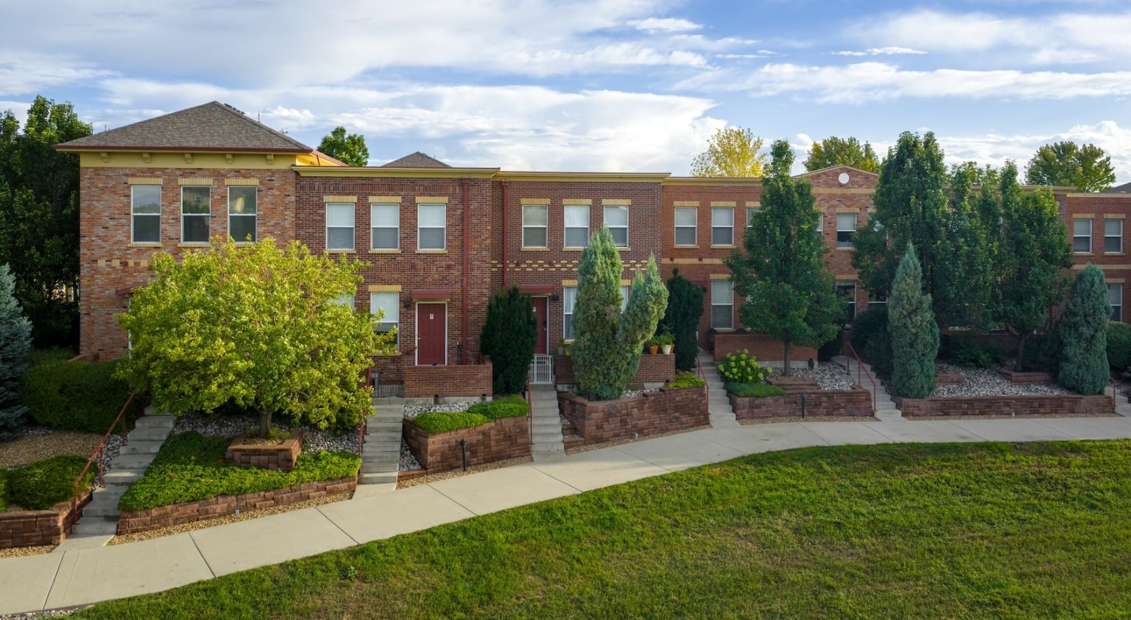 Find your perfect fit at Enclave Rigden Farms exteriors showing landscaping and accessible sidewalks