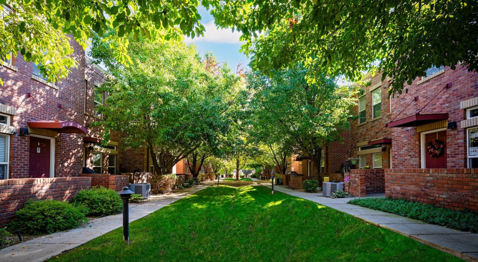 Find your perfect fit at Enclave Rigden Farms exteriors showing landscaping and accessible sidewalks