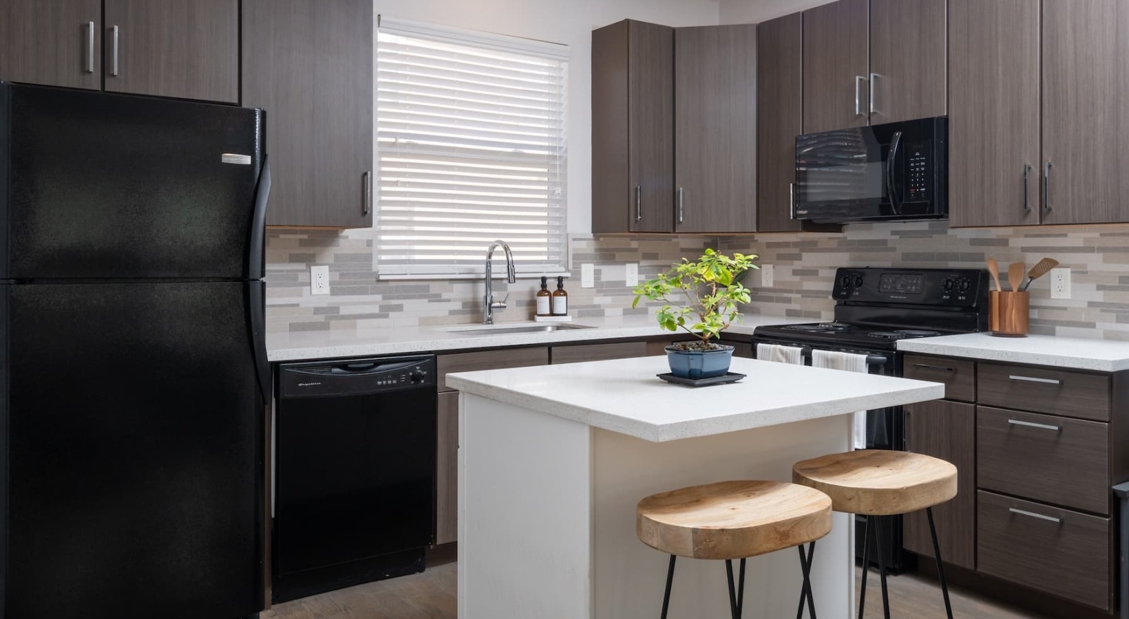 Designer finishes and modern comforts kitchen with ample counter-space and modern appliances