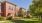 a brick building with a lawn in front of it